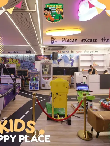 A wide shot of the arcade lounge, showing the variety of games available, including air hockey, claw machines, and video game cabinets.