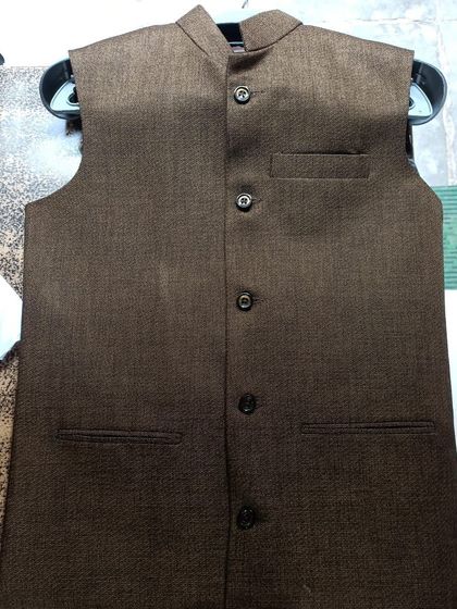 A simple and classic brown Nehru jacket, unbuttoned to show the texture of the fabric. A versatile piece that can be dressed up or down.