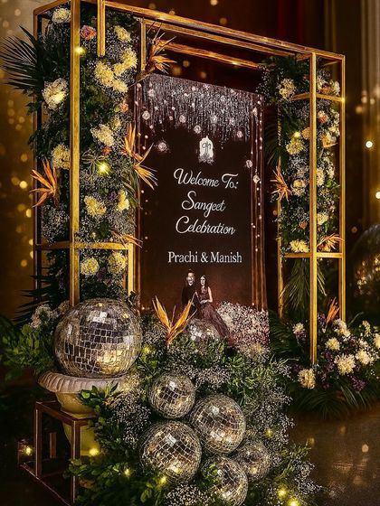 Is it a Sangeet or a Vogue cover shoot? We designed this glamorous welcome sign with a gold frame, disco balls, and tropical florals to set a high-fashion tone from the moment guests arrived.