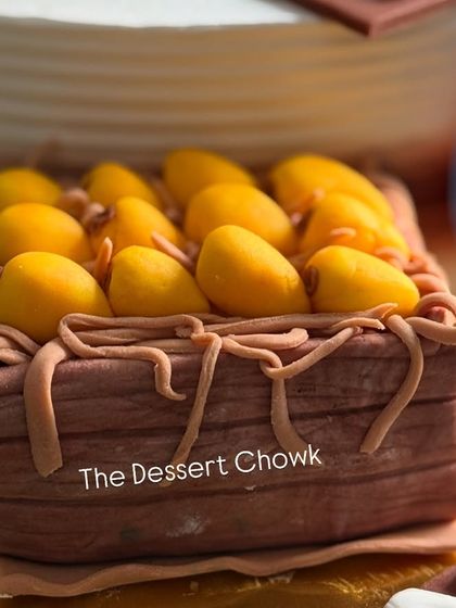 A close-up of the hand-molded fondant "aam peti" or mango crate, a special request from the client for the hobby-themed cake.