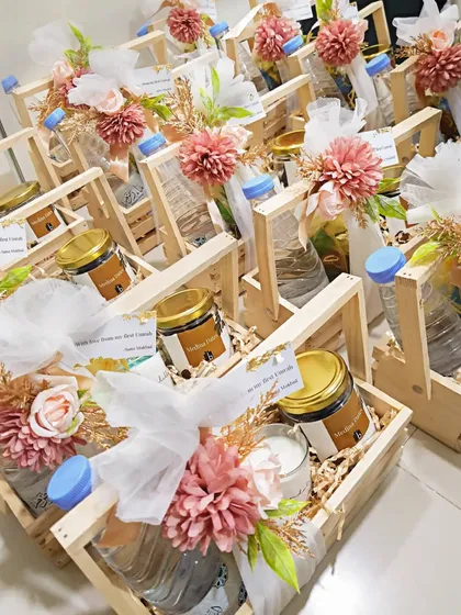 An assembly of the Umrah return gift baskets, each decorated with delicate flowers and a personalized thank you note.