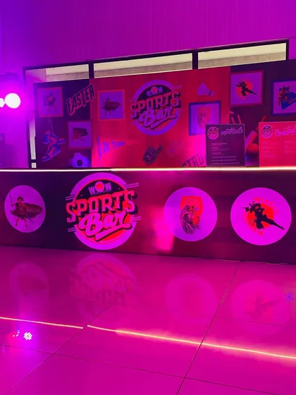Themed decor elements for the ITC 'Sports Box' event. This branded counter and backdrop served as a central hub for the party's activities.