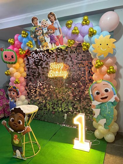 For this Cocomelon first birthday, we used a rose gold shimmer wall to add sparkle behind the colorful characters and balloons.