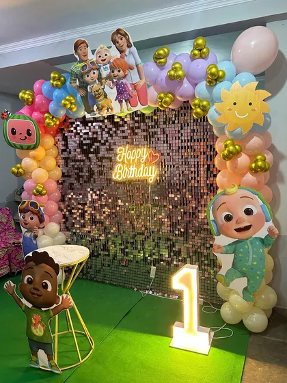 For this Cocomelon first birthday, we used a rose gold shimmer wall to add sparkle behind the colorful characters and balloons.
