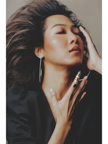 An intimate and serene portrait from the 'Patricia' series. The model's closed eyes and gentle touch convey a sense of peace and self-connection.
