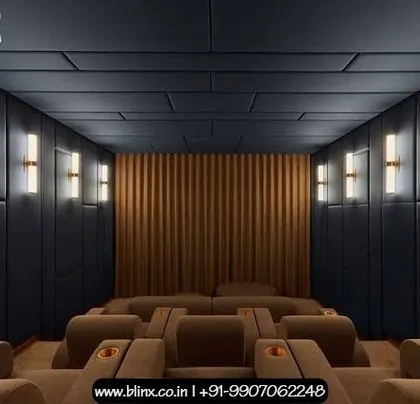 We created a bold, contemporary aesthetic in this home cinema using dark, geometric ceiling and wall panels. The warm glow from the modern brass wall sconces provides a sophisticated contrast, while the plush brown seating ensures maximum comfort.