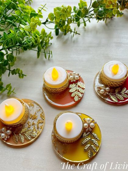 A set of beautiful, handcrafted resin tea light holders with battery-operated candles. The warm colors and gold leaf accents make them perfect for any festive occasion.