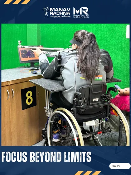 A para-athlete demonstrates intense concentration as she aims her rifle from a specialized wheelchair setup at our 10m indoor range. My program focuses on creating adaptive solutions that empower every shooter to find their perfect form and achieve focus beyond limits.