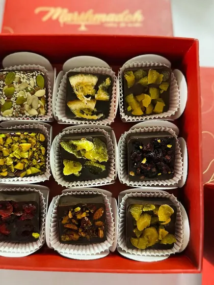 A closer look at my guilt-free chocolate bites. I use pure couverture chocolate and top it with a variety of nuts, seeds, and exotic dried fruits like apricots and cranberries. There is no added sugar, just pure, natural flavour.
