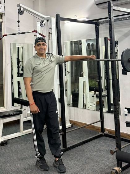 A relaxed pose by the squat rack.