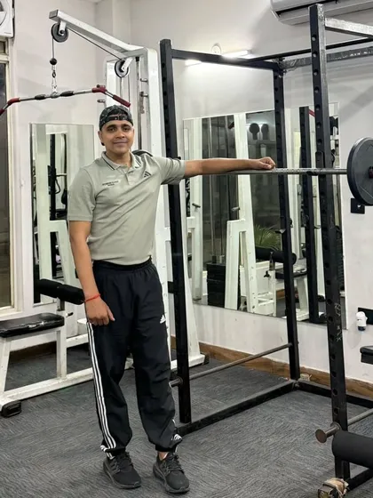 A relaxed pose by the squat rack.