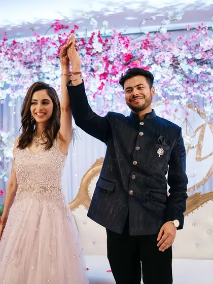 The grand entrance and presentation of the newly engaged couple to their guests, with hands held high in celebration.