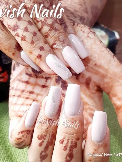 Clean and simple light pink nails with a subtle silver glitter line on one accent nail, providing an elegant look for any bride.