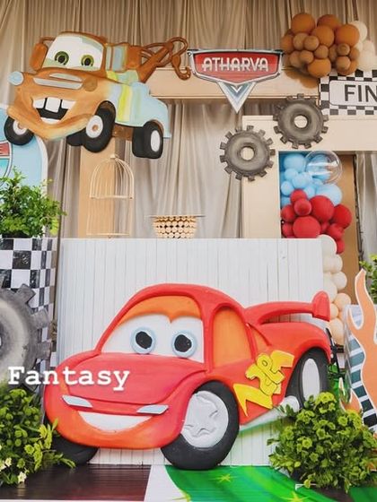 A full stage setup for Atharva's Disney Cars birthday. The scene is packed with characters like Lightning McQueen and Mater, along with Route 66 signs, cacti, and gas station props.