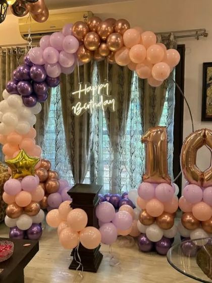 A beautiful pastel and rose gold theme for a 10th birthday. The semi-arch and number balloon columns create a soft and pretty look.