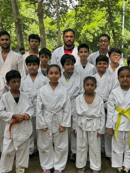 Another proud group photo from our outdoor grading. You can see the mix of belts, showing a community of learners at all different stages.