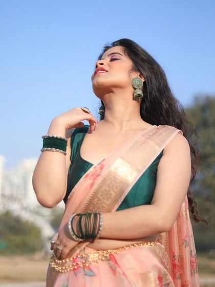 A sunlit portrait highlighting a glamorous party look. The pink eyeshadow and glowing skin catch the light beautifully, creating a radiant finish for this outdoor shoot.