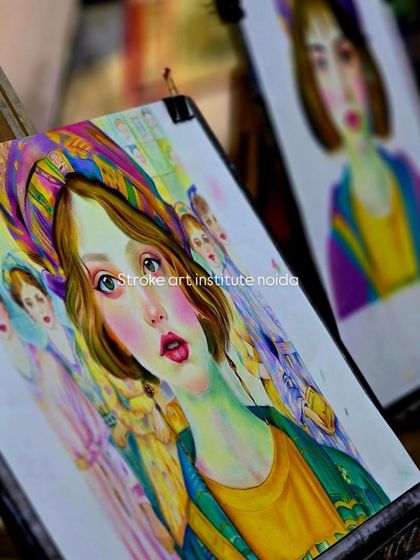 Two student projects side-by-side on easels. This image showcases the progress and beautiful results of our soft pastel portrait workshops.