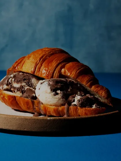 Another experimental shot, this time an ice cream croissant sandwich against a bold blue background. The unusual combination and dramatic lighting make for a striking visual.