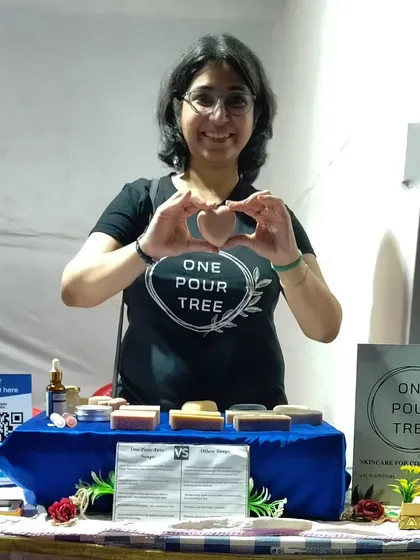 Me holding a heart-shaped soap at the Hasta Rachana Fair. These are always a hit!