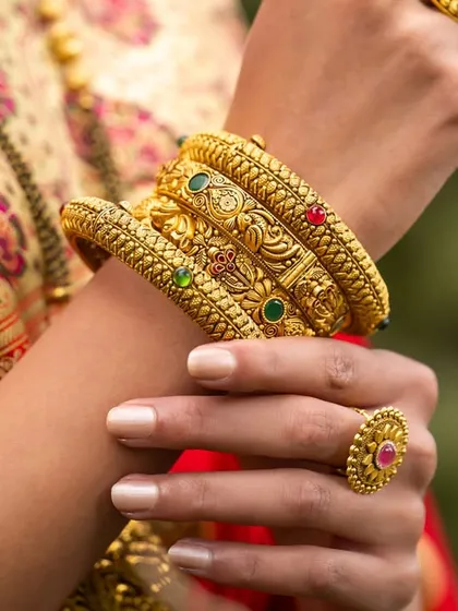 A detailed macro shot of the intricately designed gold bangles, demonstrating my ability to capture product details.
