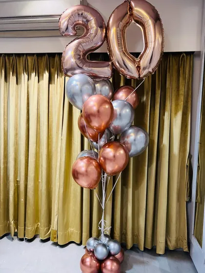 Turning 20 in style with this gorgeous rose gold and silver balloon bouquet. The large number balloons make a huge statement for any milestone birthday.