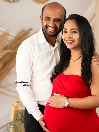 A happy and bright couple's portrait, where the red dress adds a touch of romance to the relaxed boho setting.