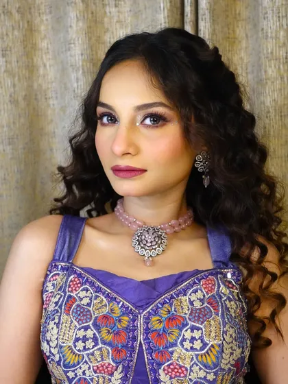 A front-facing shot of the model, looking confident and beautiful in her vibrant Haldi attire.