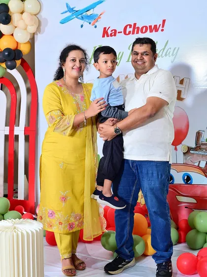 A lovely family portrait in front of the custom 'Cars' party backdrop.