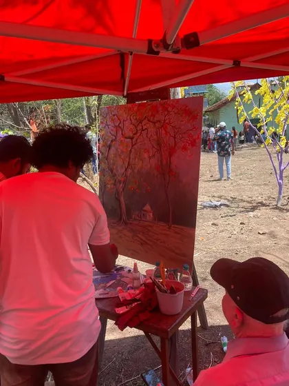 The painting in progress under the tent at the Gulmohar festival.