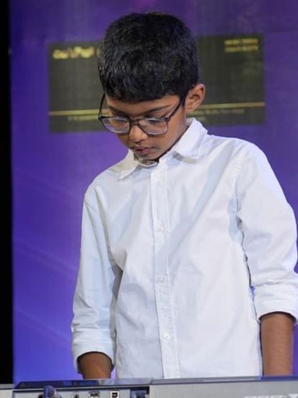 Deep in concentration, this young keyboardist delivers his performance.