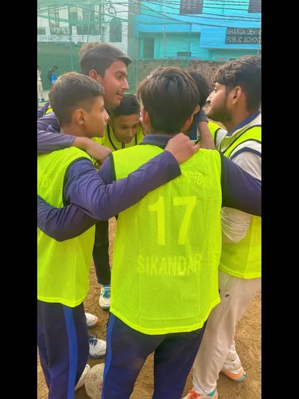 A close-up of the team huddle. The determination is visible in their eyes.