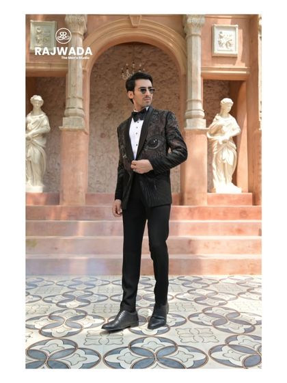 A full-length shot of the eye-motif tuxedo, demonstrating its slim, modern fit and undeniable artistic flair.