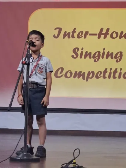 A young singer performs with poise and confidence on stage. Our performing arts programs are designed to build these essential life skills.