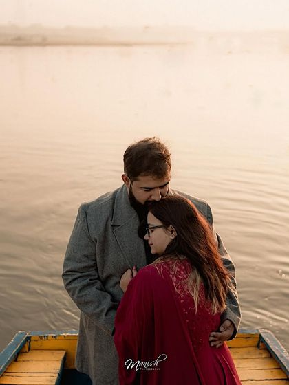 A comforting embrace on the water as the sun sets. This image from their pre-wedding shoot is filled with warmth and emotion.