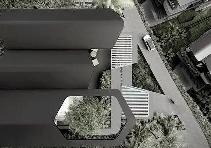 An aerial view of the Dona Paula homes, showcasing the unique hexagonal cutouts in the roof structures. These openings allow for rooftop gardens and light wells, bringing nature directly into the home and breaking down the mass of the building.