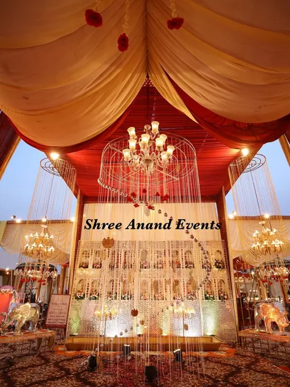 An elaborate entrance piece featuring a caged chandelier and a backdrop of a traditional haveli facade, creating a grand sense of arrival.