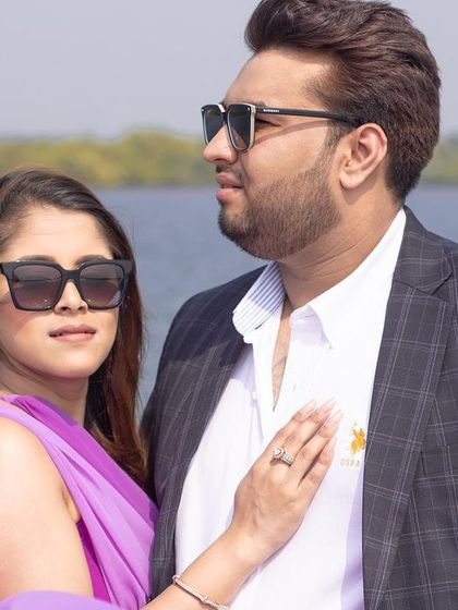 A close-up, loving portrait of the couple on their Goan yacht adventure, capturing their connection and the beautiful seaside light.