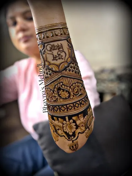 A bride showing off her unique bridal mehndi, which includes Punjabi phrases. This is a wonderful way to personalize a design.