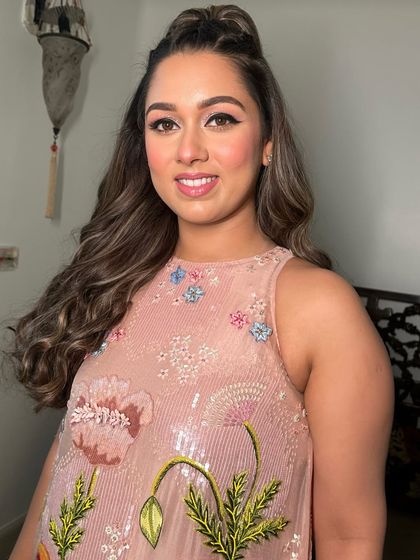 A close-up of the glistening pink makeup, highlighting the shimmery eye and the radiant skin.