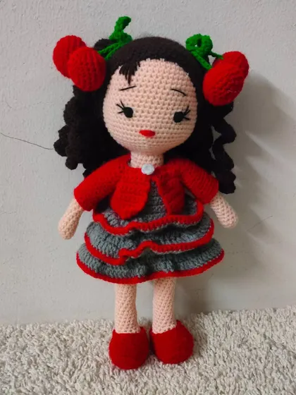 A closer look at the doll with the cute cherry hair clips and a layered dress.