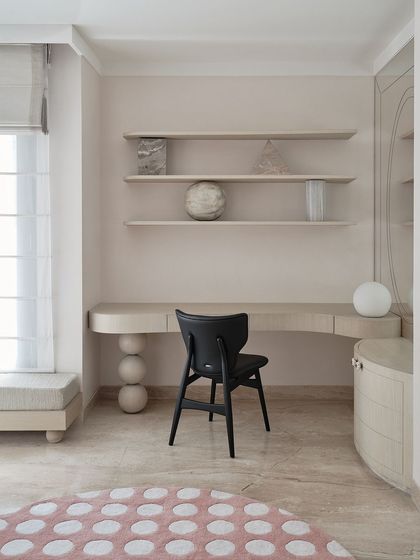 A wider shot of the study area, showing the clean lines of the desk and the elegant black chair. The space is designed to be both inspiring and functional, with ample natural light.