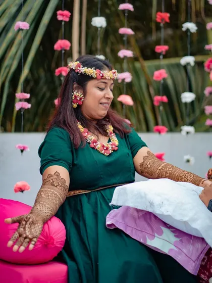 A beautiful portrait of a client at her mehndi ceremony, her arms covered in my intricate henna patterns.