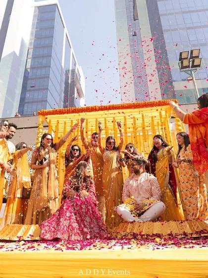 A Haldi ceremony is all about joy and vibrancy. We love creating fun, interactive moments like this petal shower, set against a backdrop of traditional marigolds for the perfect blend of tradition and fun.