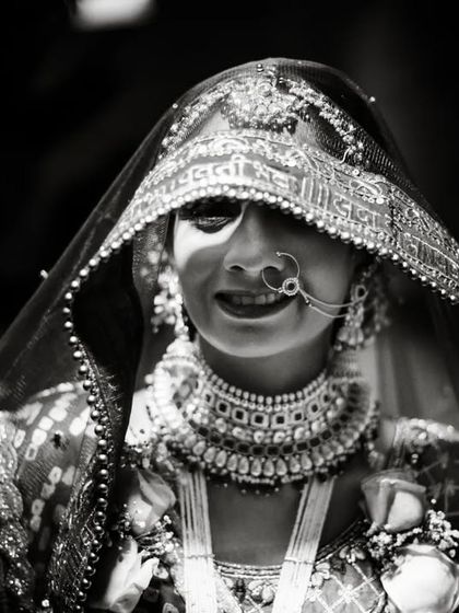 A beautiful, happy bride in her traditional Gujarati wedding attire.