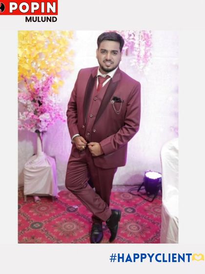 A happy client in a maroon three-piece suit, looking ready for a wedding celebration. The color is festive and the fit is perfect.