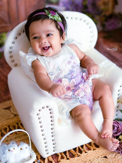 A girl like a pearl. This three-month-old's happy smile and beautiful floral outfit make for a truly precious portrait.