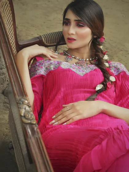 This fuchsia pink pleated maxi dress features an off-shoulder neckline with a contrasting floral embroidered yoke. It’s a perfect example of my indie-chic style, combining comfortable, modern design with intricate, traditional details.