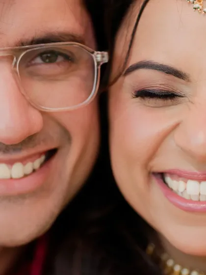 A creative close-up shot showing half of each of their smiling faces, symbolizing their union into one happy whole.