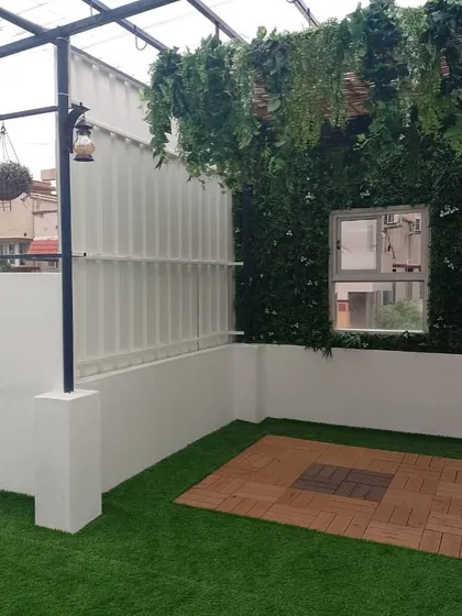 This renovation was for a passionate mother who had clear ideas for her space. We added a green wall, hanging plants from the pergola, and a mix of turf and deck flooring to create her dream terrace garden.